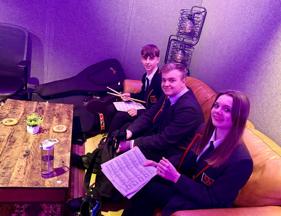 Big Sing students sat on sofa