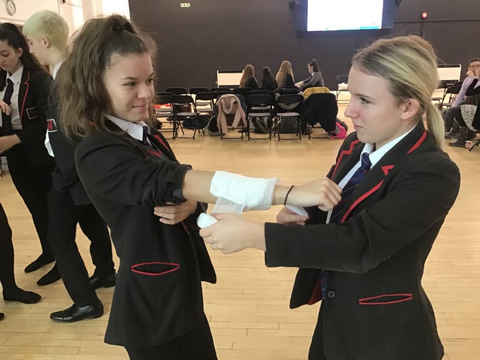 Girls wrapping a bandage 